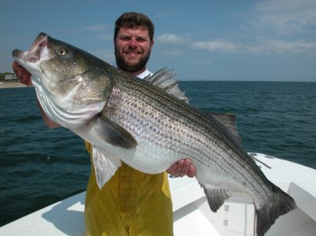 Captain Eric Stapelfeld with a trophy striped bass caught on Hairball Charters