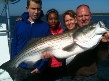 family catches striped bass off of Cape Cod