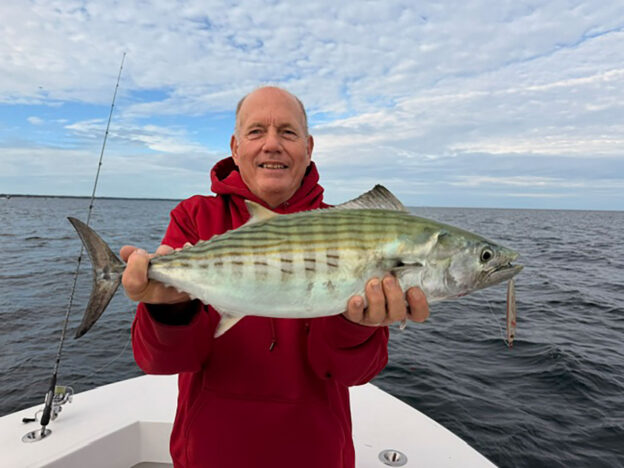 Angler holding an Atlantic bonito on a Cape Cod fishing charter boat